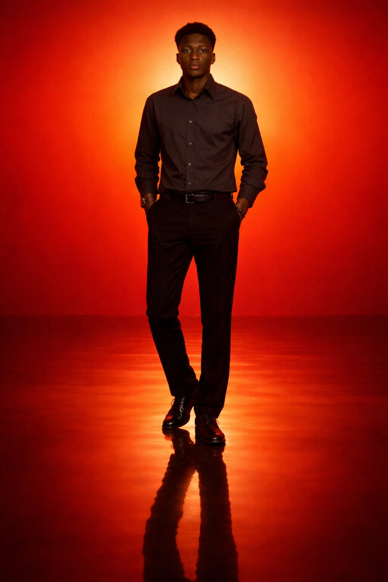 GPT Image 2 photoreal full-body studio portrait of a tall Black man in a fitted black shirt and trousers under deep-orange rim light